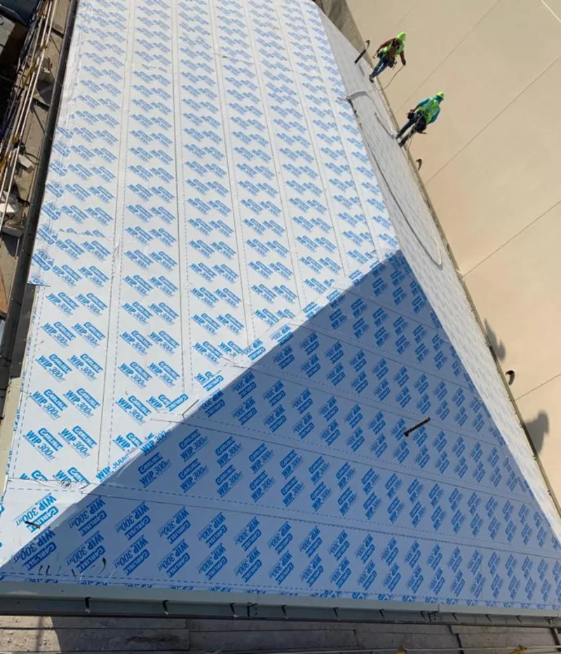 Professional roofers installing underlayment on a metal roof in Lakemoor